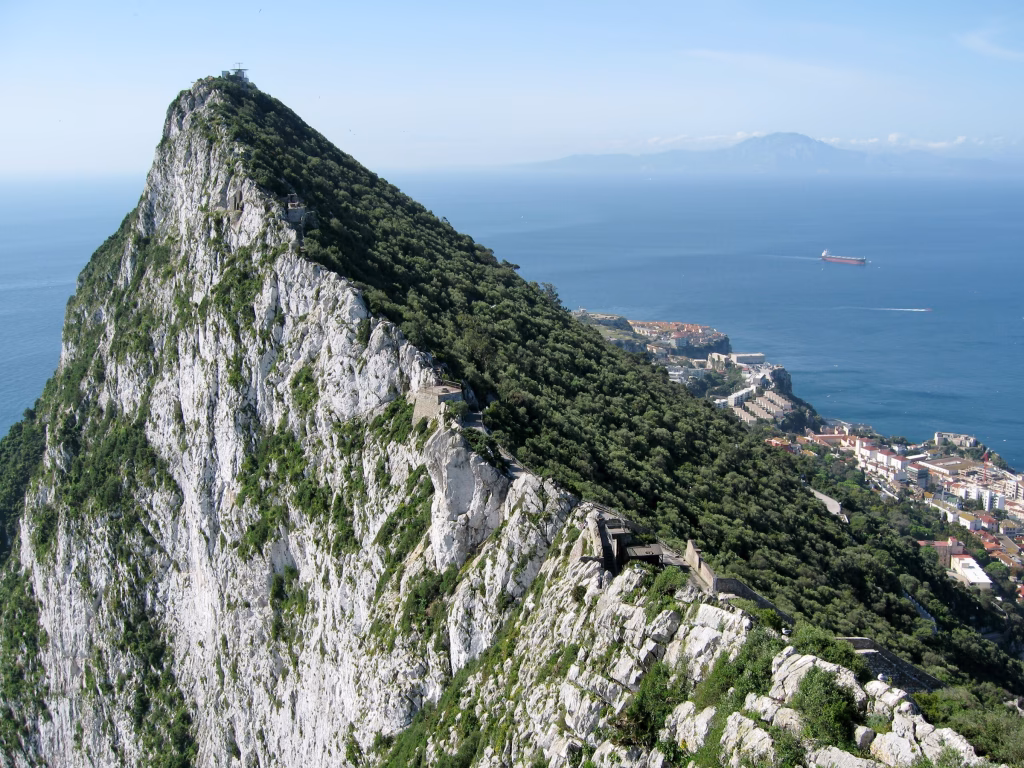 Limestone ridge of the Rock of Gibraltar with town below and Strait beyond